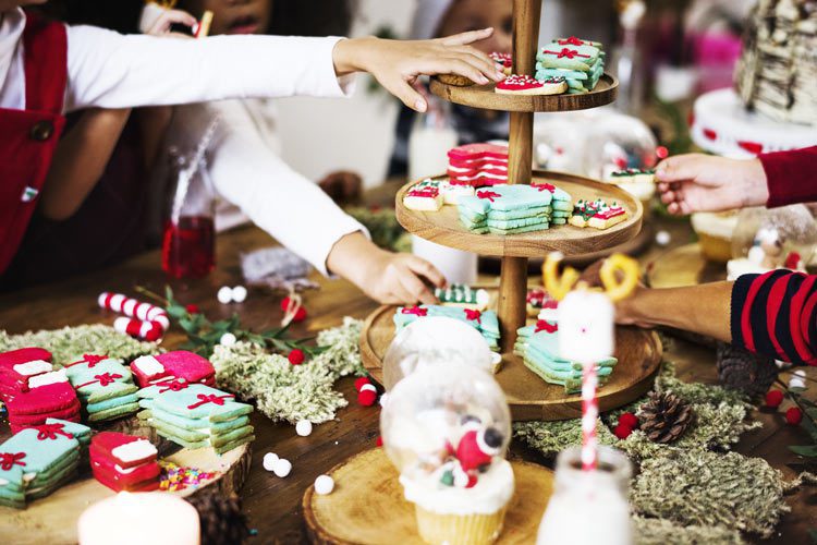 table filled with Christmas cookies and cupcakes - sugar